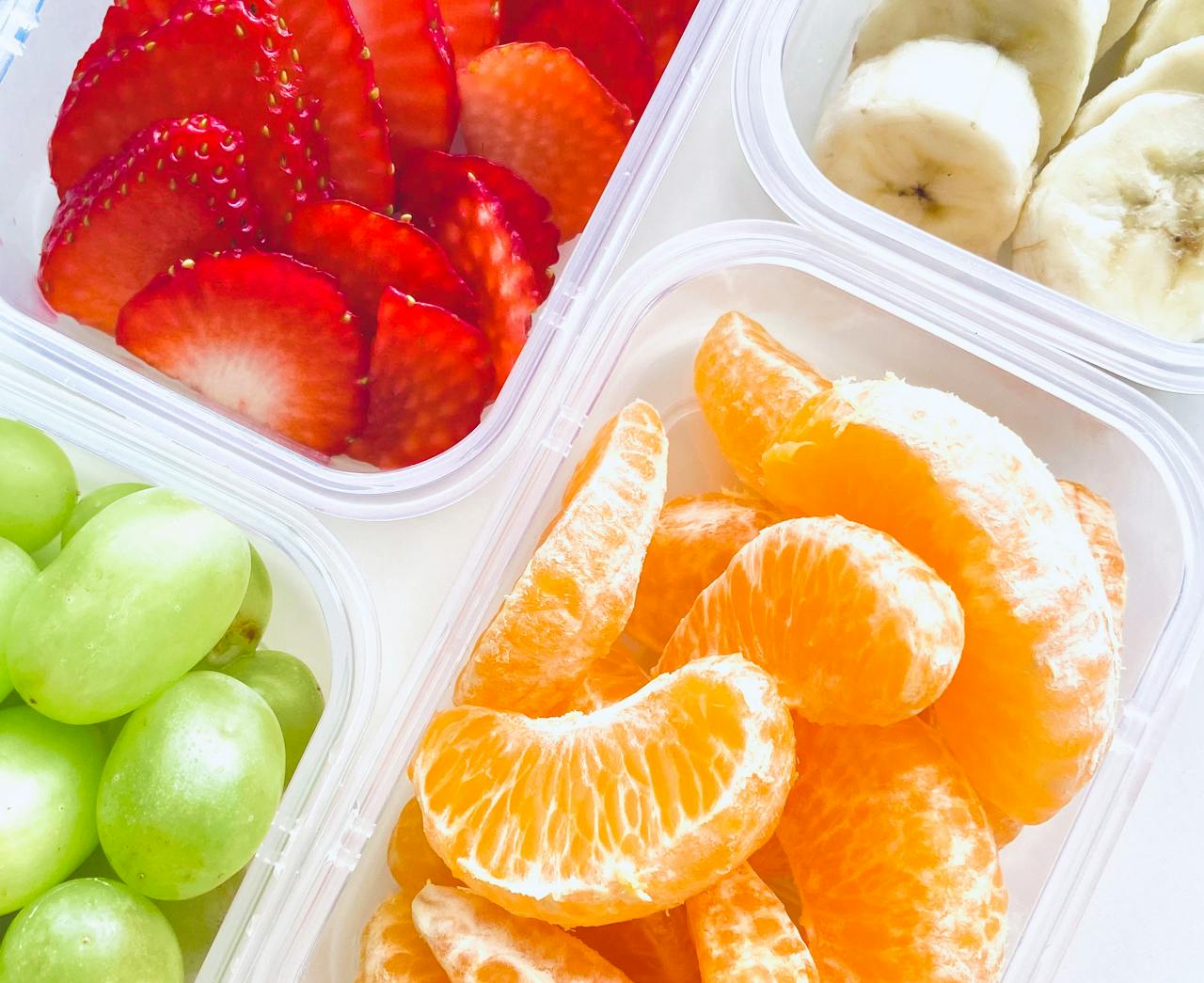 A Photo of Colorful Fruit in Containers