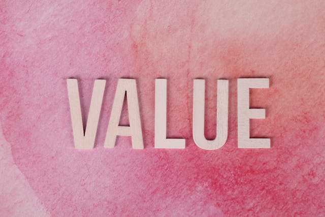 The word "VALUE" on a pink red background