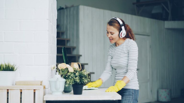 Woman Cleaning Indoors with Headphones and Plants